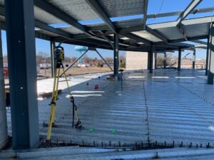 Robotic layout equipment positioned near structural steel
